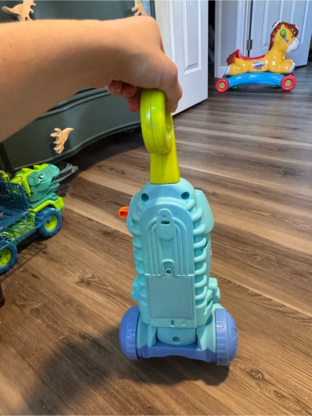 Fisher-Price Light Blue Toy Vacuum with Yellow-Green Handle and Purple Wheels